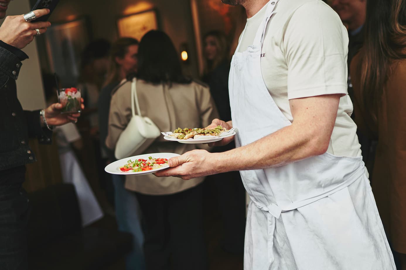 Thomas Straker carrying plates at Straker's restaurant on Golborne Road, Notting Hill, London